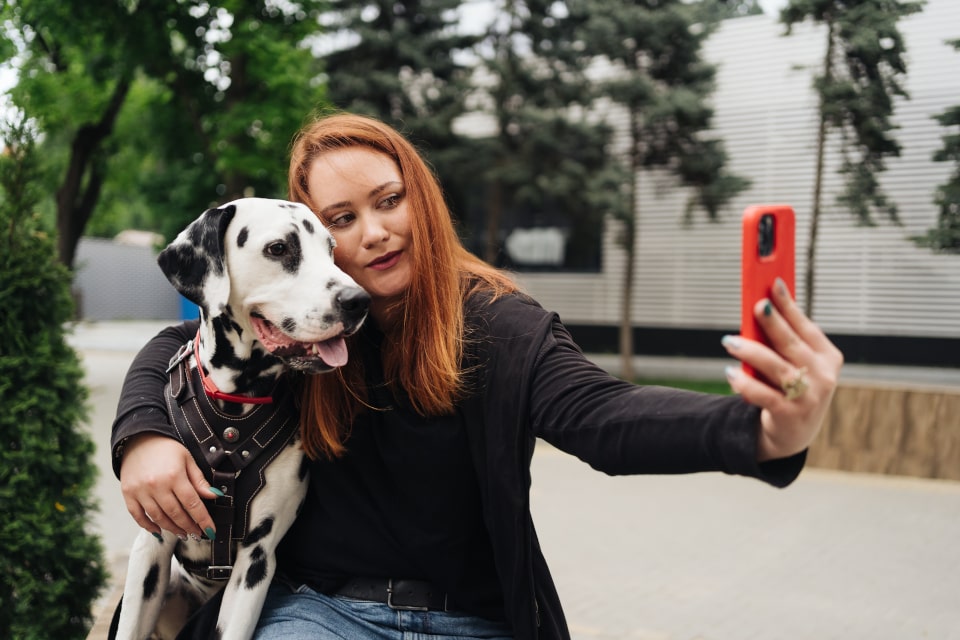 Woman taking a selfie with a dalmatian