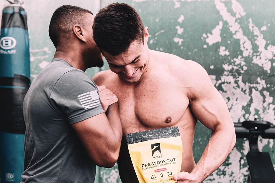 Influencer marketing manager showing appreciation to an influencer holding a product to improve influencer relations by giving a shoulder bump