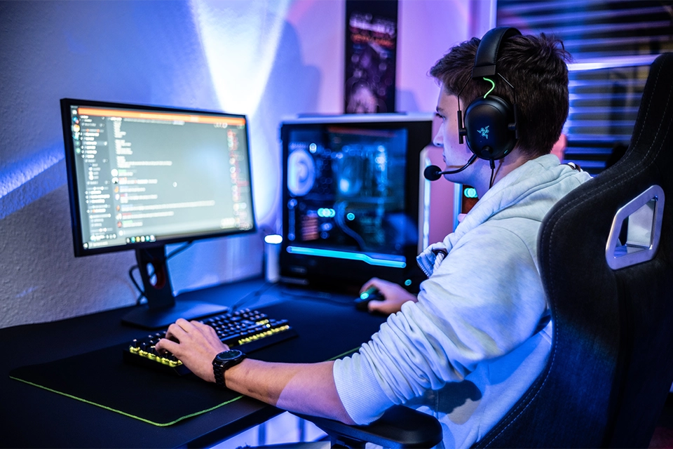 Person sitting at a computer looking at a Discord marketing strategy