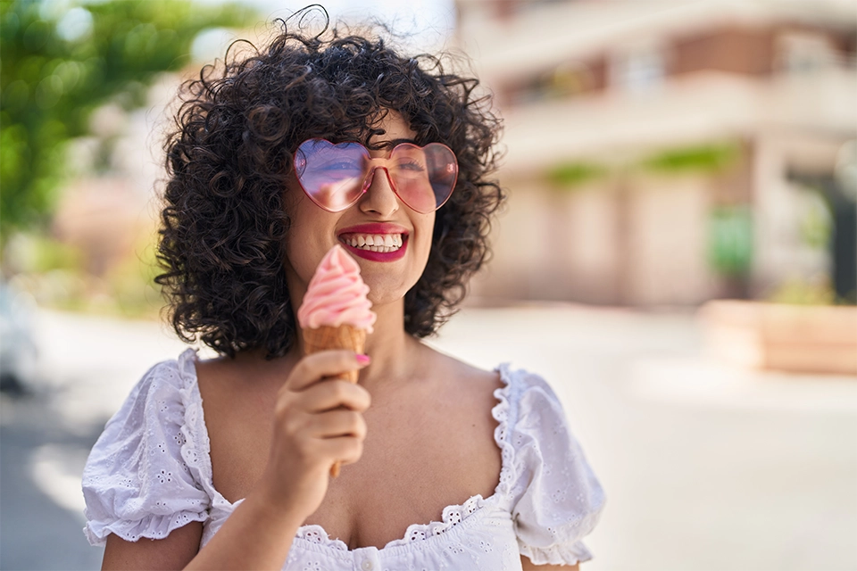 Woman smiling and holding an ice cream cone