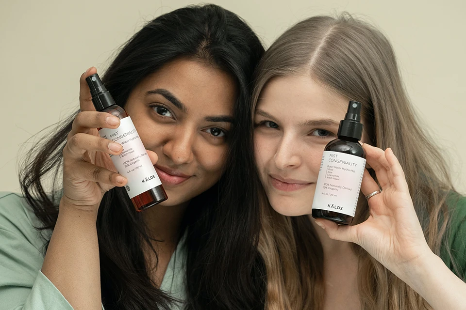 Two women holding up the same product