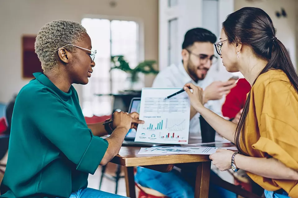 Two marketers going over influencer reporting numbers
