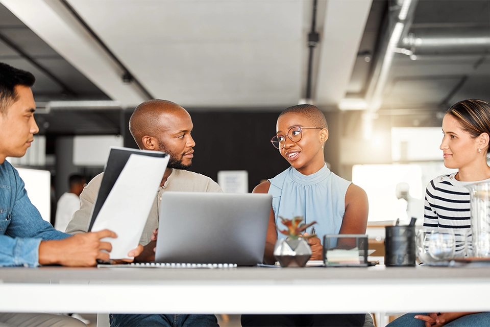 A group of coworkers discussing influencer marketing software