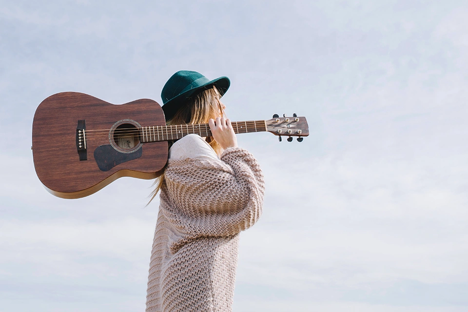 Woman with a guitar across her shoulder