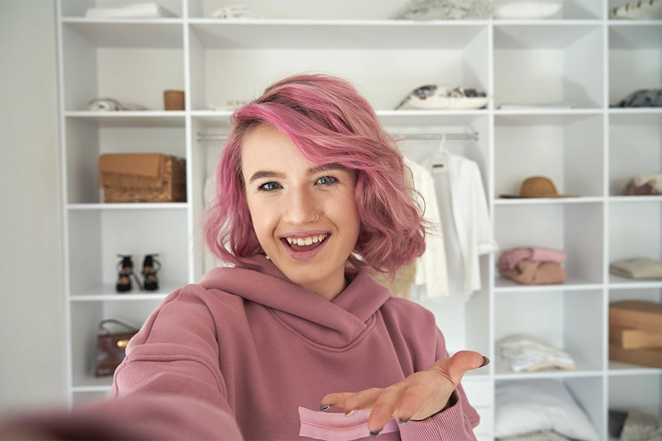Teen girl with pink hair taking a selfie