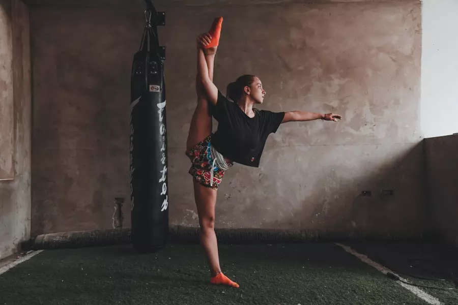 athlete influencer stretching in a gym