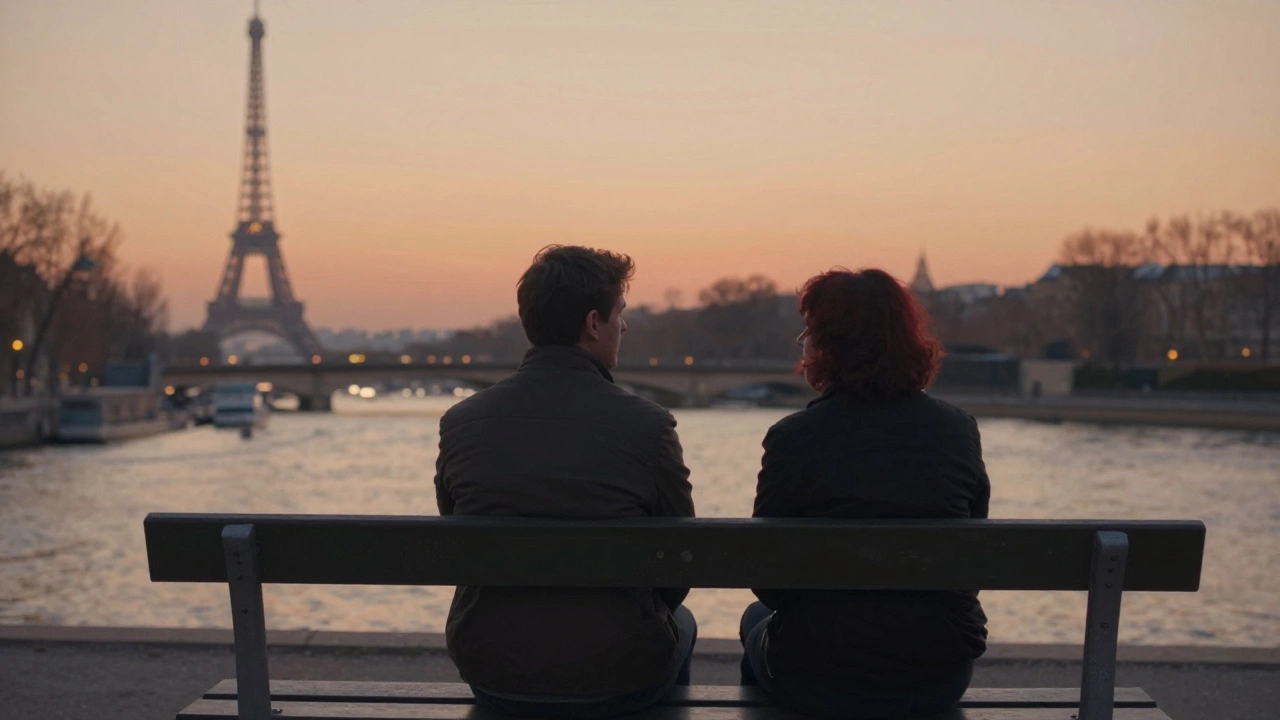 Two people sit silently on a bench by the Seine at sunset, sharing a moment of quiet companionship.